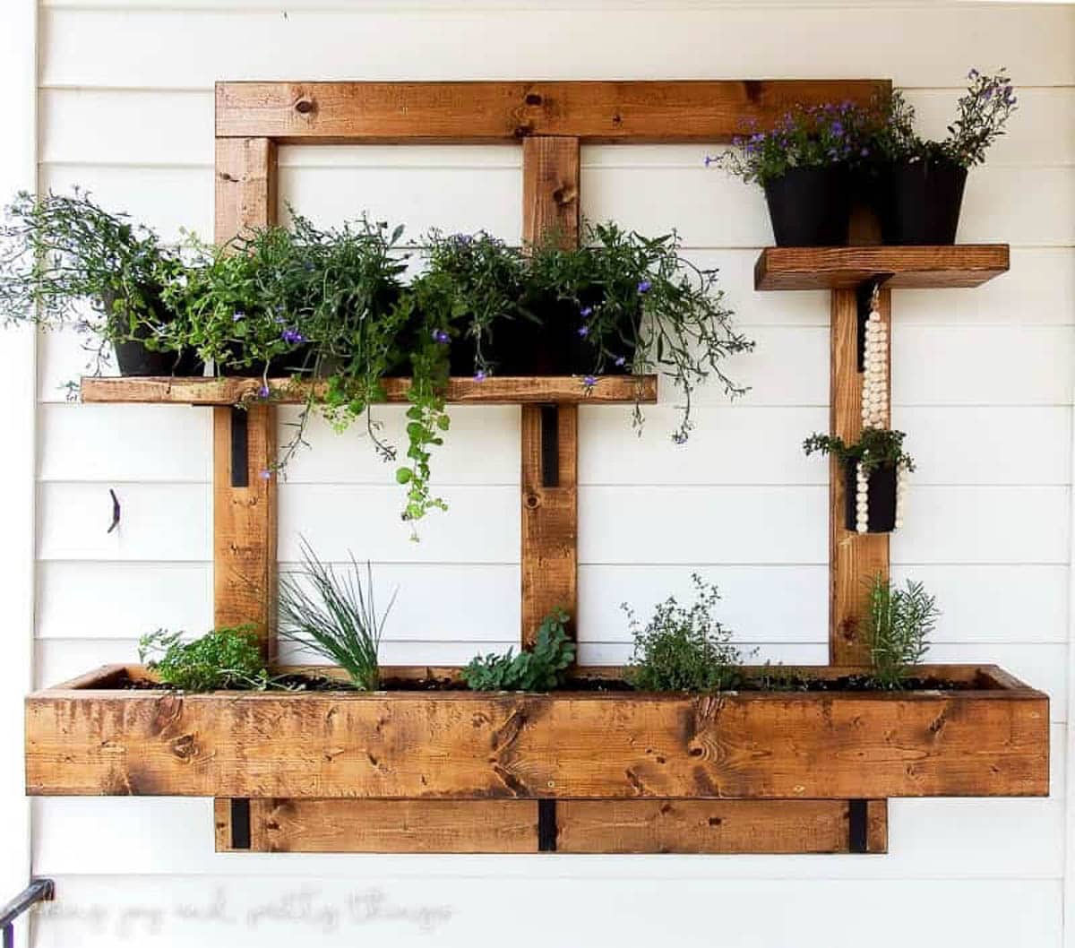 vertical planter made from 2x4s attached to the house 
