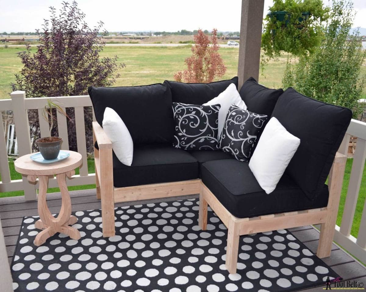 DIY outdoor love seat made with 2x4s with black cushions