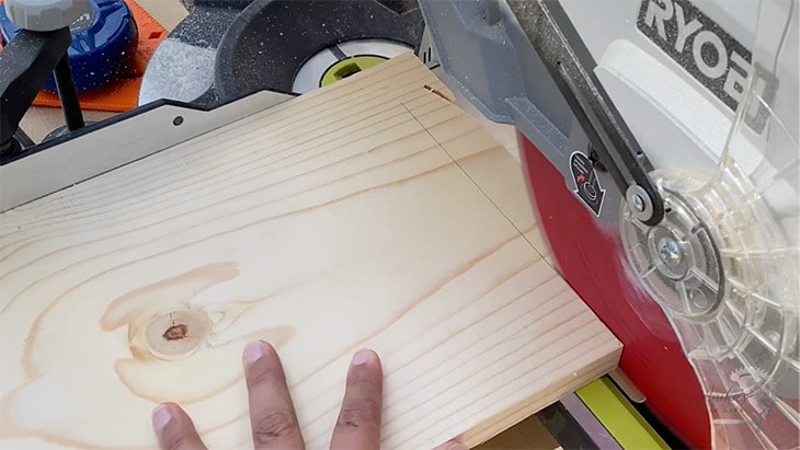 miter saw cutting on a board accurately on the line
