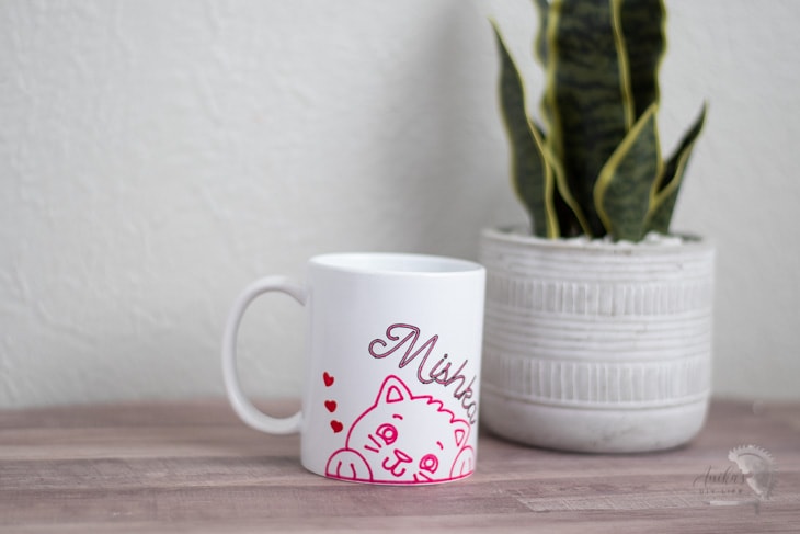 Cricut mug made using infusible ink markers on a table