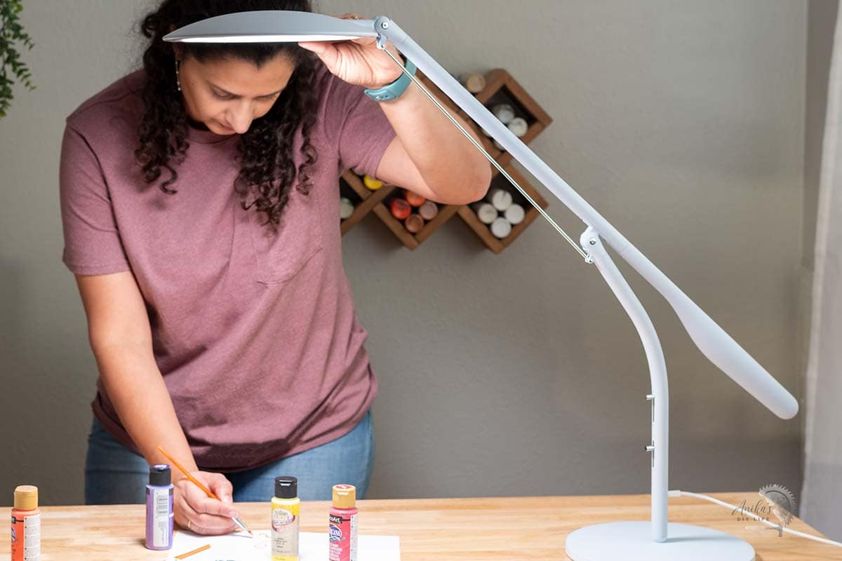 woman painting on table with Cricut Bright 360