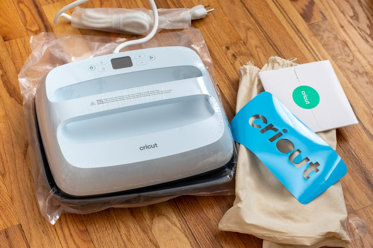 Cricut EasyPress 3 and other items in the package on the floor
