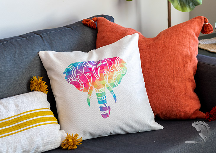 Pillow made with colorful influsible ink on couch