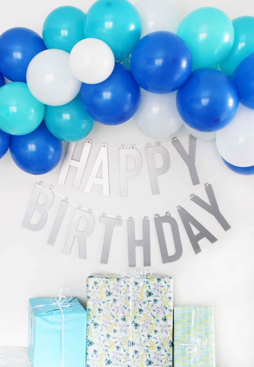 blue and white ballon garland with happy birthday banner made from chipwood using a Cricut Maker