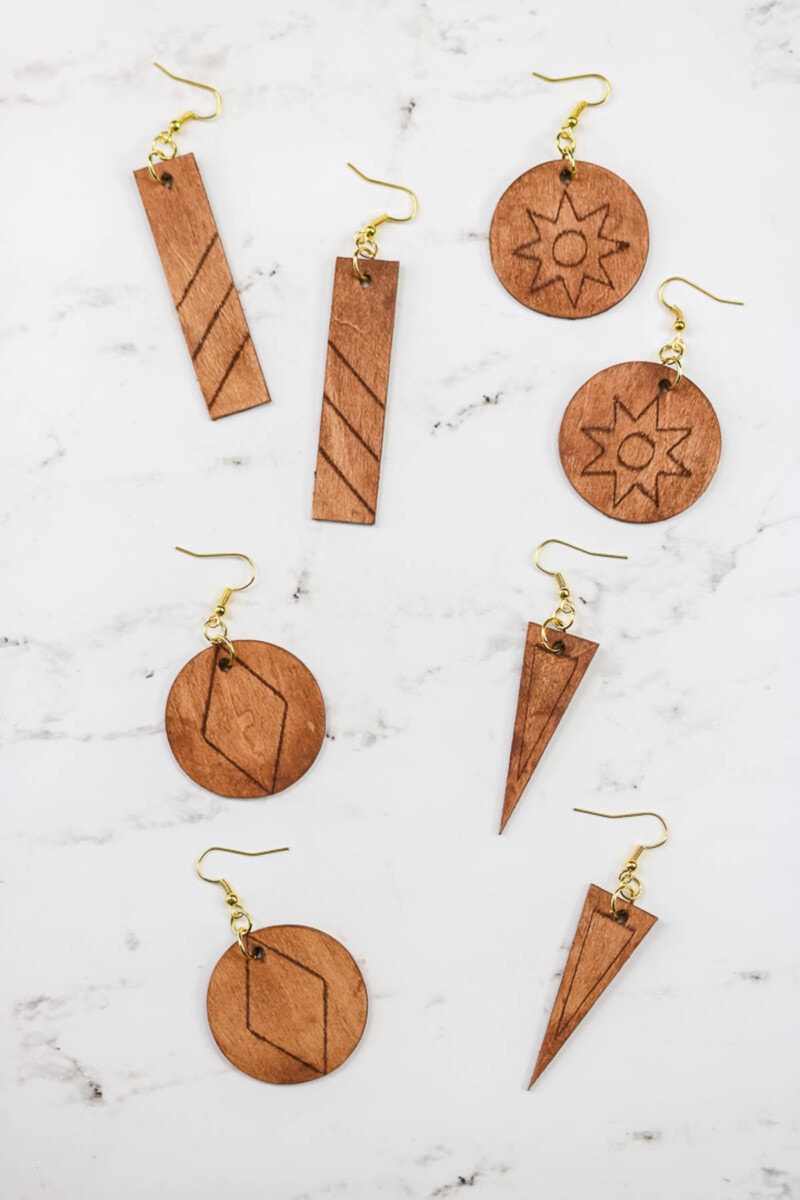 four pairs of wooden earrings in different shapes