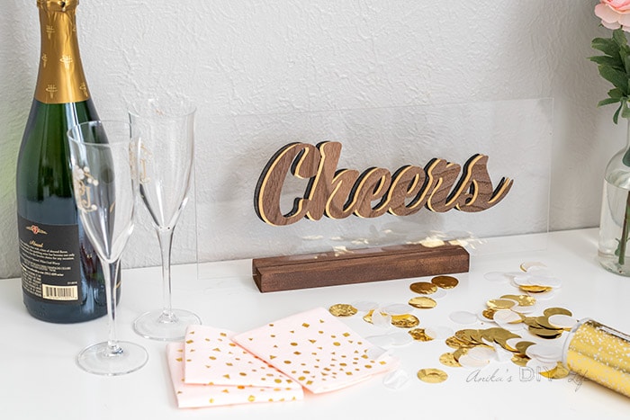 Cheers sign on table with champaign and napkins