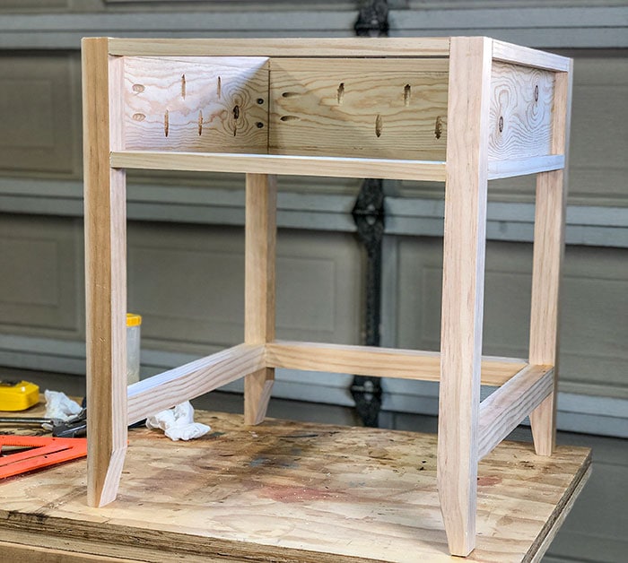 Frame of DIY end table with charging station built on a workbench
