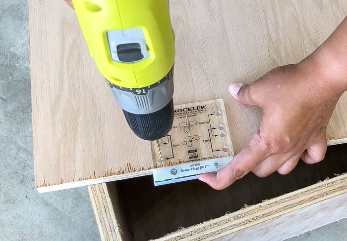 Making pilot holes in the lid using Lid Stay Torsion Hinge JIG IT by Rockler