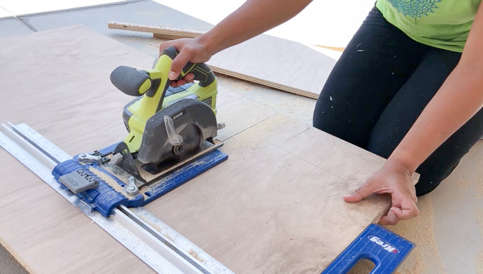 Cutting plywood to make the DIY entryway shelf with storage