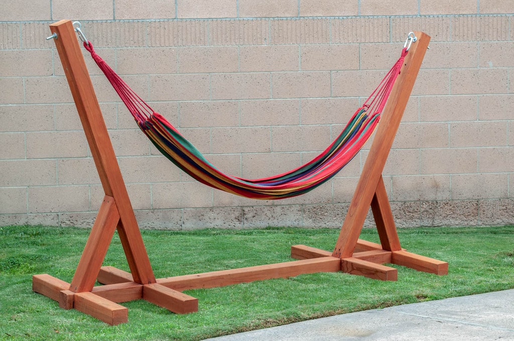 DIY Hammock stand made with wood with a colorful hammock on it.