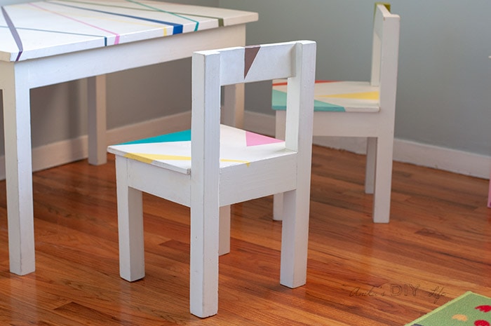 White children's table and chair set with colorful abstract designs