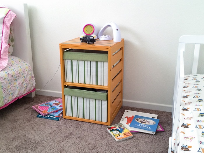 Before of the kids room with old nightstand and books