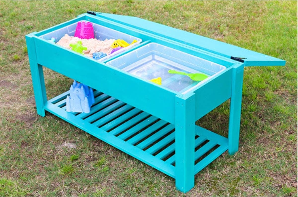 kids DIY sand and water table with the lid open and storage rack underneath
