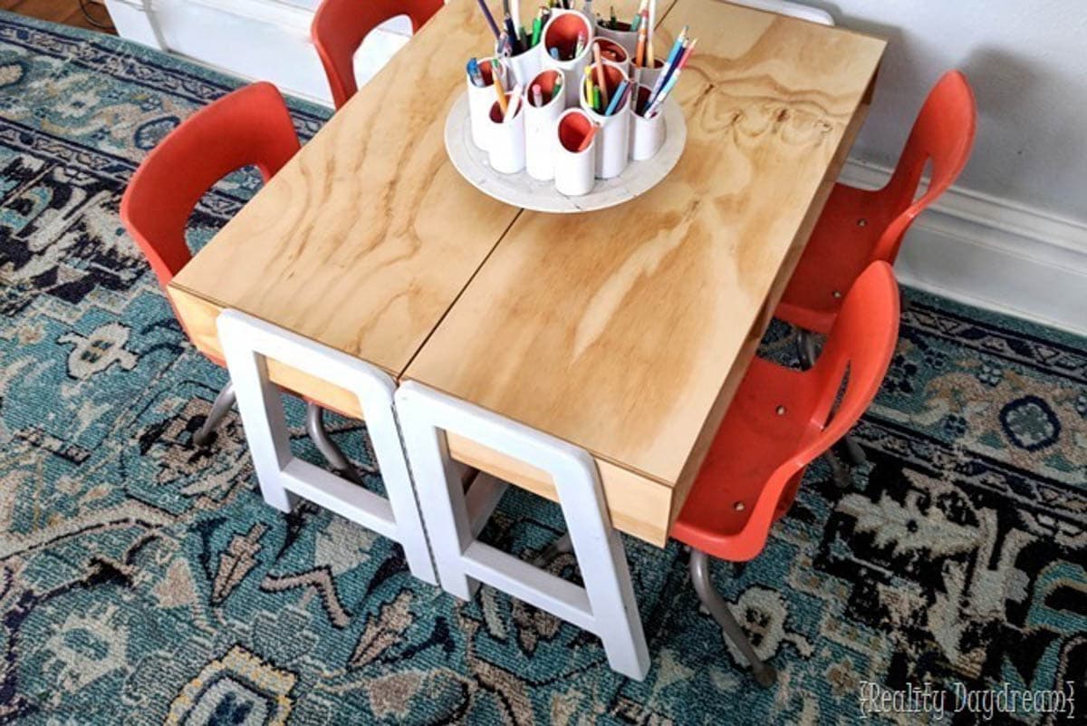 Two single kids craft tables made into one big craft table with four chairs