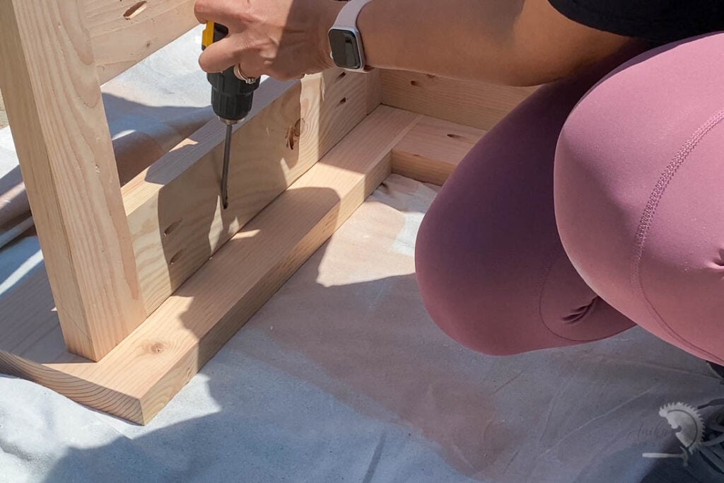 woman attaching legs frame to counter top using pocket hole screws 