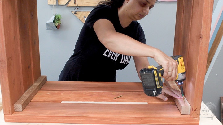 Woman building the outdoor storage box
