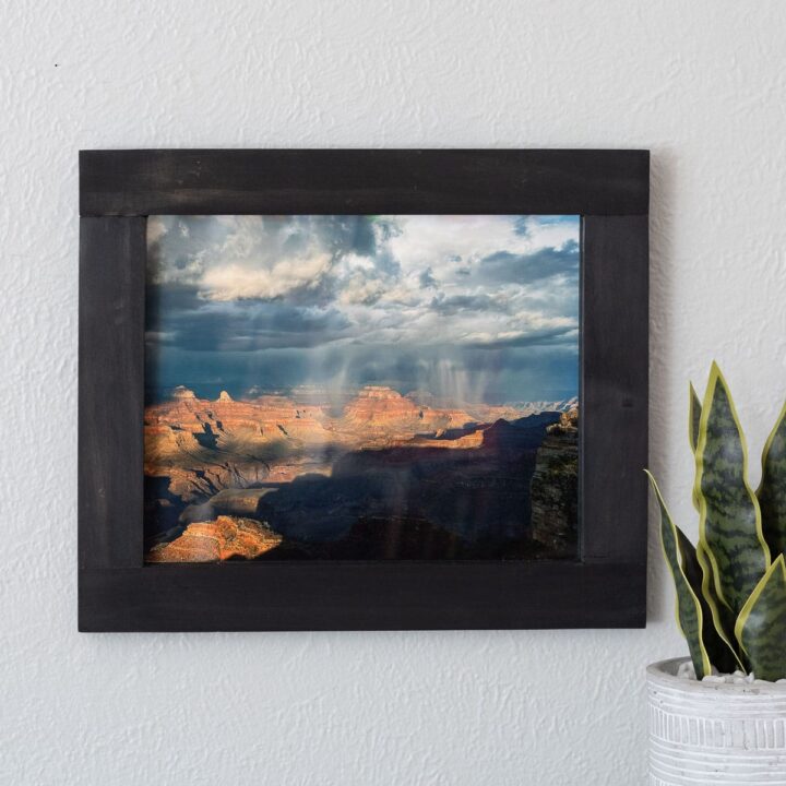 Learn how to make a wall-mounted custom picture frame of any size using half-lap cuts with this detailed step-by-step guide.