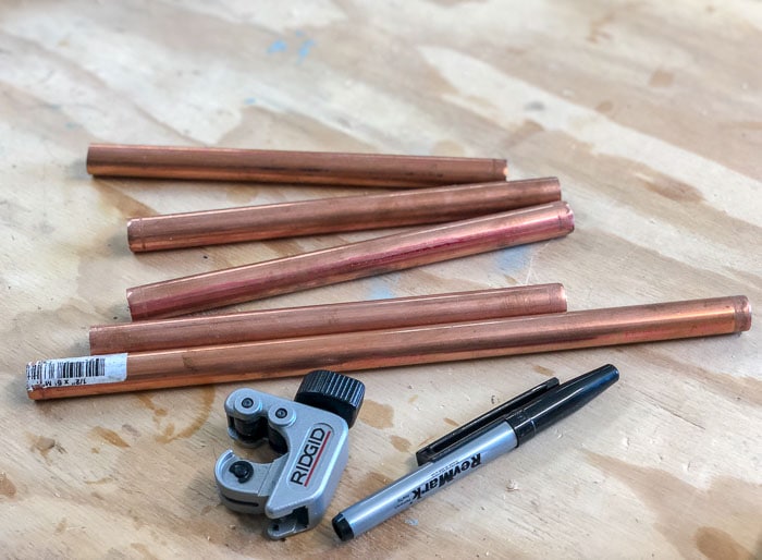 Copper tubes cut up to make the stakes for the ring toss game