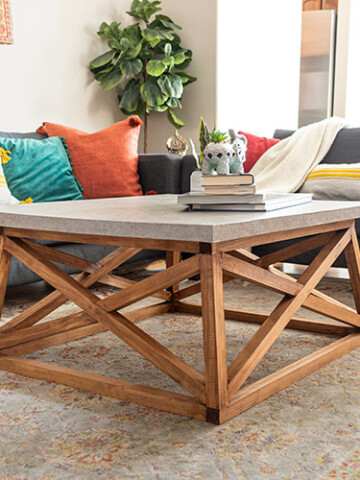 Learn how to build a Serena & Lily inspired DIY square coffee table with angled X-legs. This budget-friendly DIY uses a trick to mimic the concrete top too!