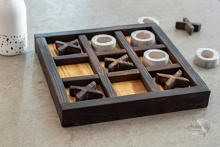 DIY wooden Ti-Tac-Toe game on a coffee table
