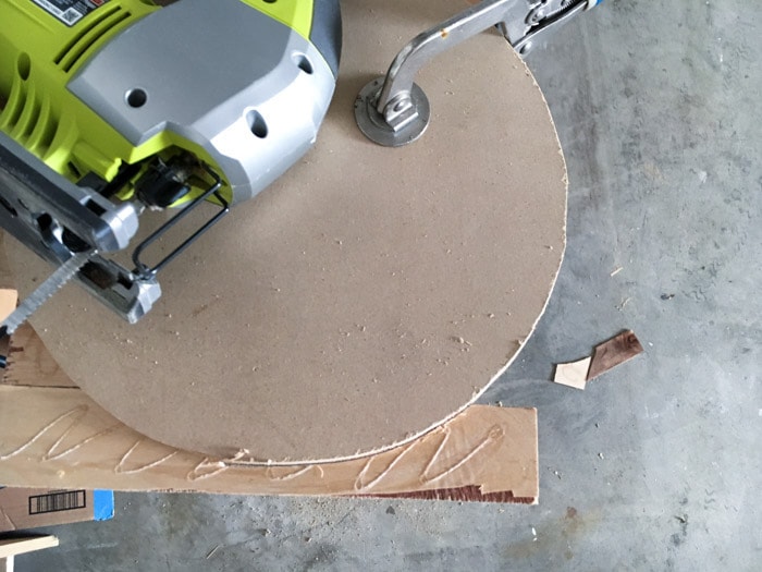 cutting off the overhanging pieces of plywood on the DIY wood wall clock