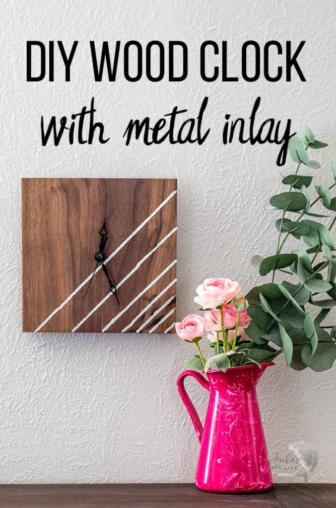 DIY wood clock with metal inlay on wlal next to pink roses with text overaly
