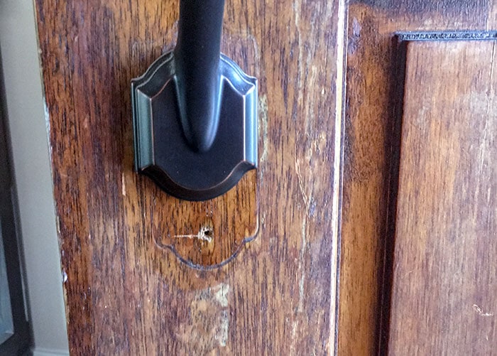 old hardware on old door before front door makeover 