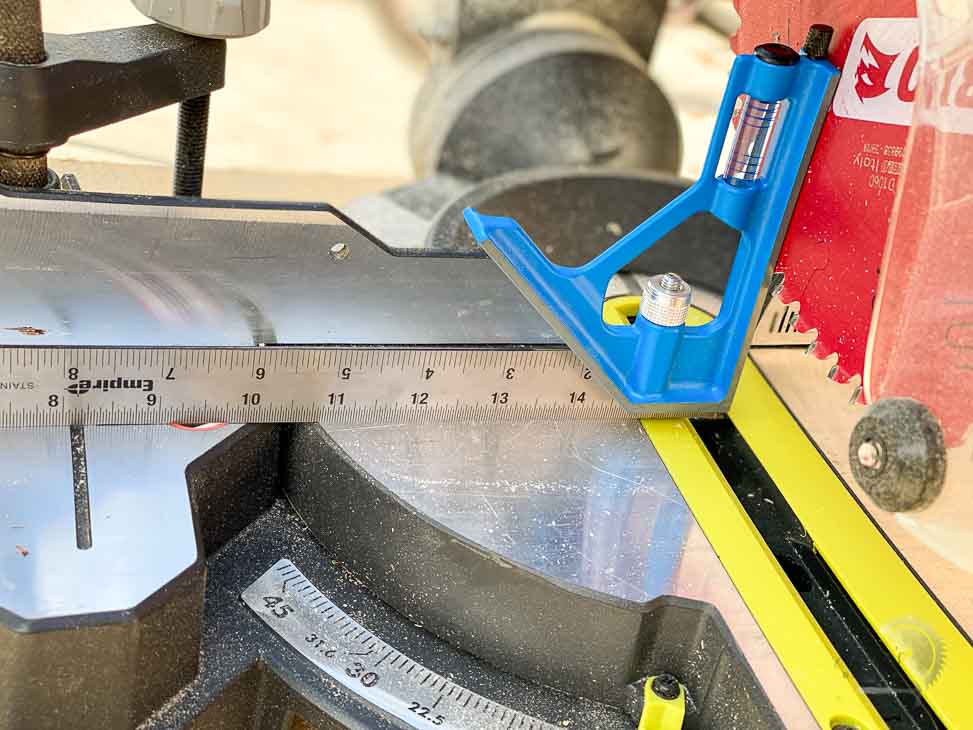 using a combination square to align the table on a miter saw