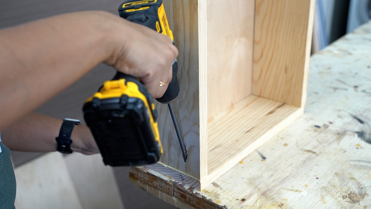 building the drawer by attaching the side with pocket holes