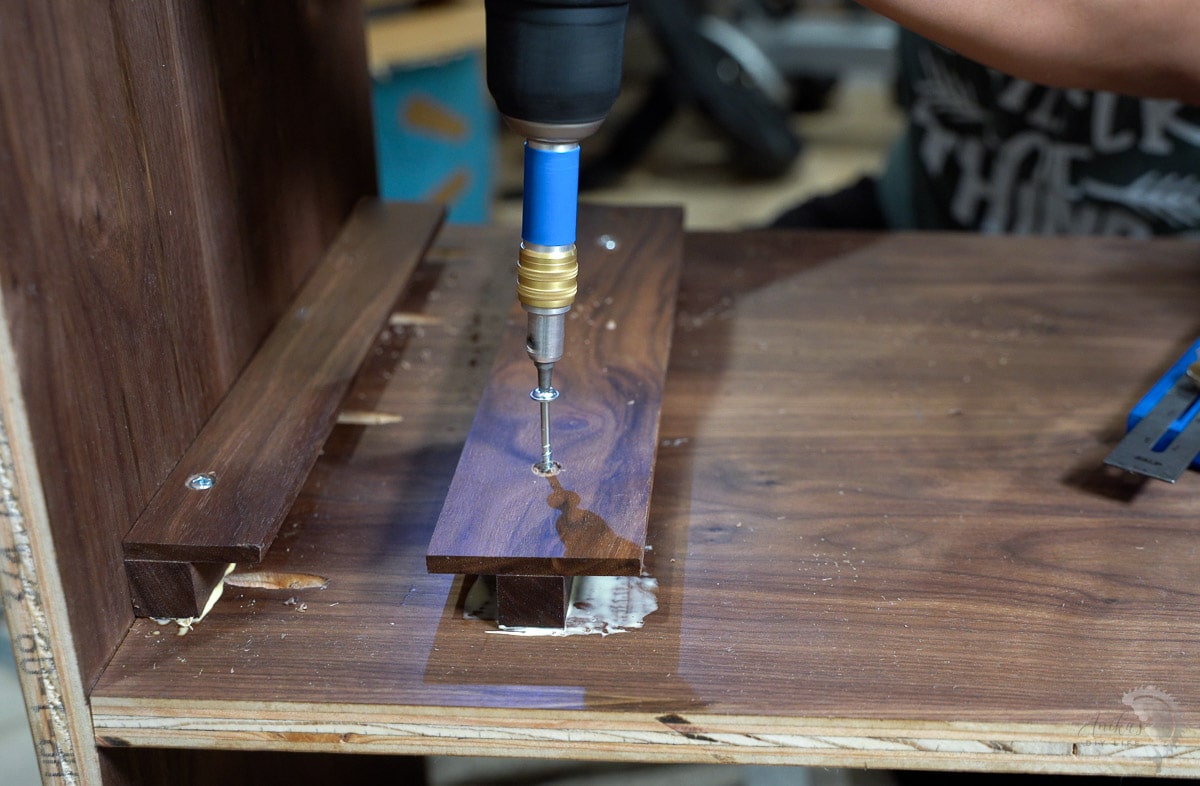 Attaching wine glass holder to the bar cabinet with screws