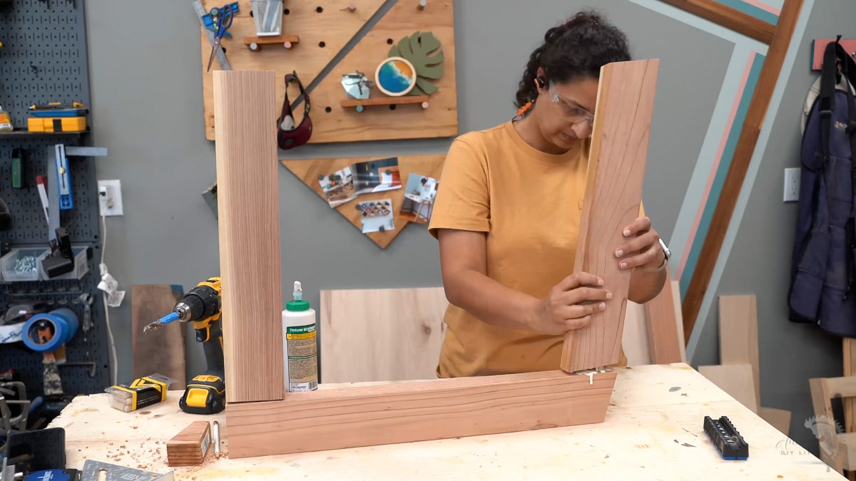 Woman building the arm rest using dowel joinery