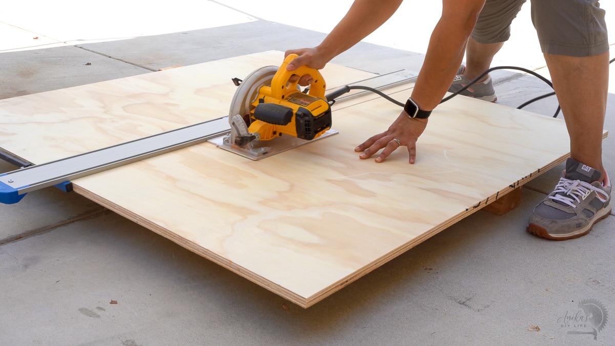 woman cutting plywood with circular saw 