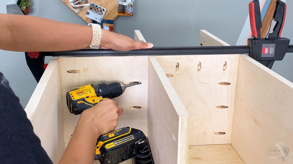 woman building the drawer dividers and shelves