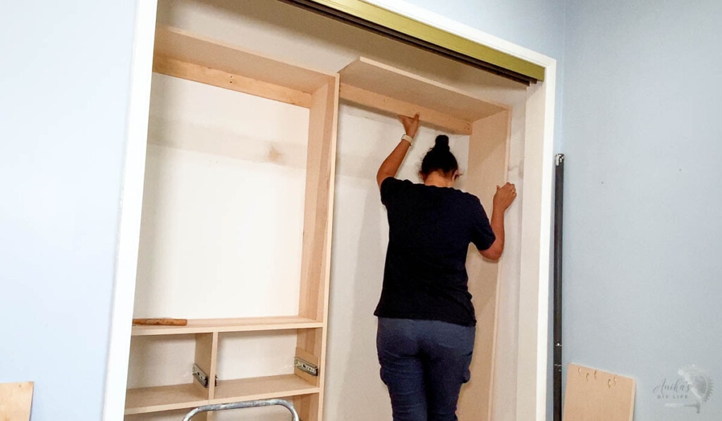 Woman installing the second side of the custom closet