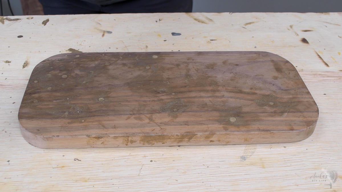 walnut board with brass inlay before sanding