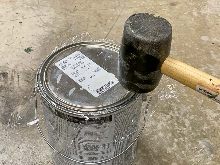 Tapping the paint can closed with a mallet