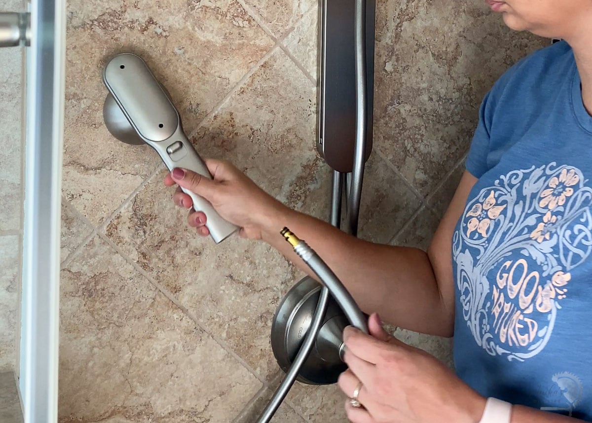 woman connecting the handshower to Nebia by moen