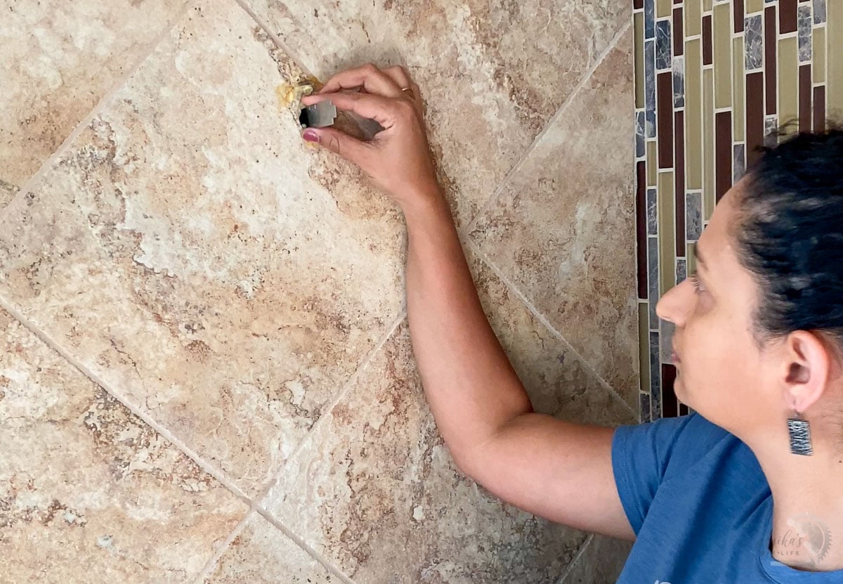 Woman measuring depth of the hole for showerLOVE this shower! It is not only a great upgrade but it uses about half the water which is so good for the earth.