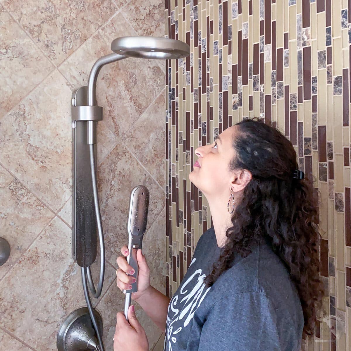 woman looking at the installed Nebia by Moen Spa Shower