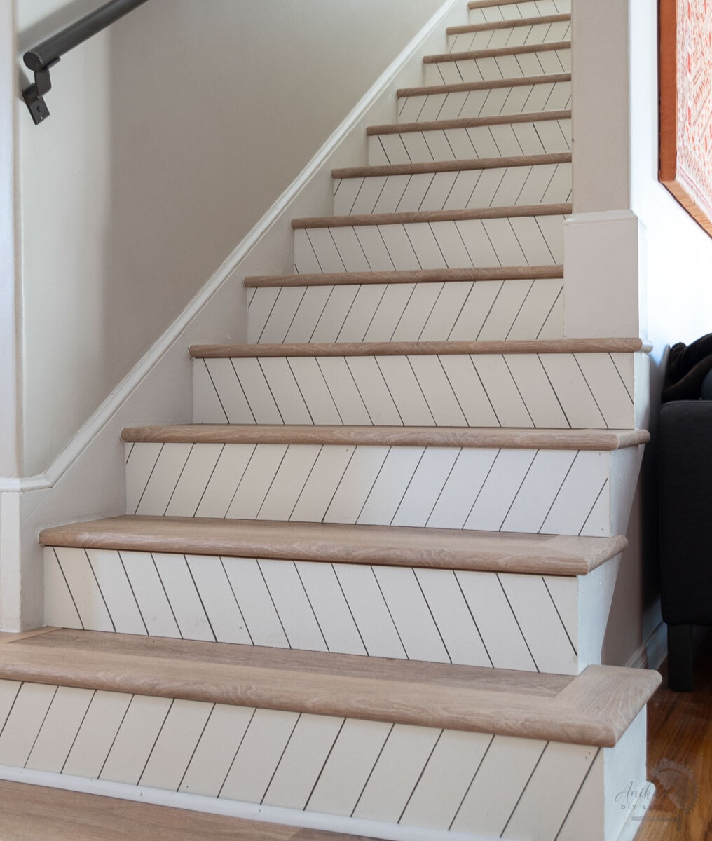 Stairs with vinyl plank flooring and zigzag stair risers