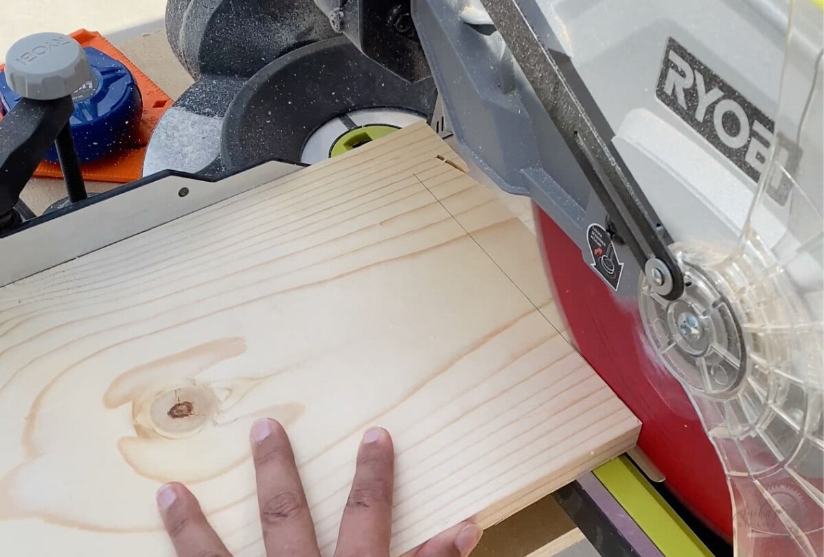 making the cut with a miter saw on a board